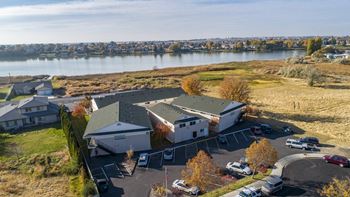 an aerial view of a house with a lake in the background  at The Lakes Apartments, Moses Lake, Washington